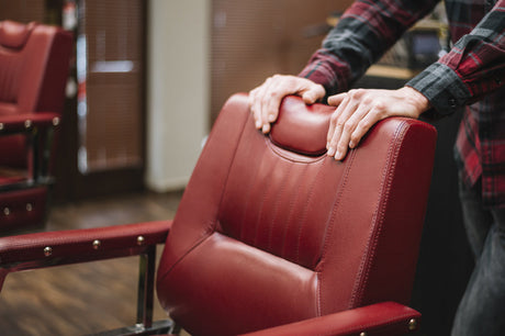“Person reupholstering an armchair using fabric, staple gun, and padding for a professional-looking furniture makeover.”