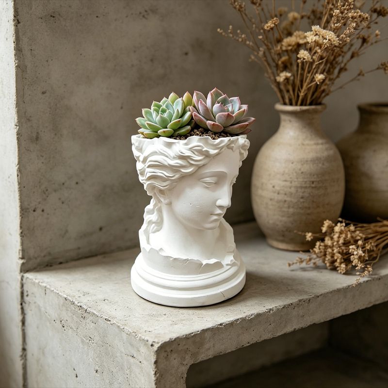 A 3D-printed, broken goddess-themed flowerpot, combining decorative and functional elements, in white.