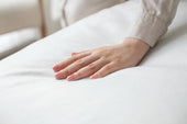 “Mattress topper placed on top of a standard mattress, adding an extra comfort layer for improved support and softness.”