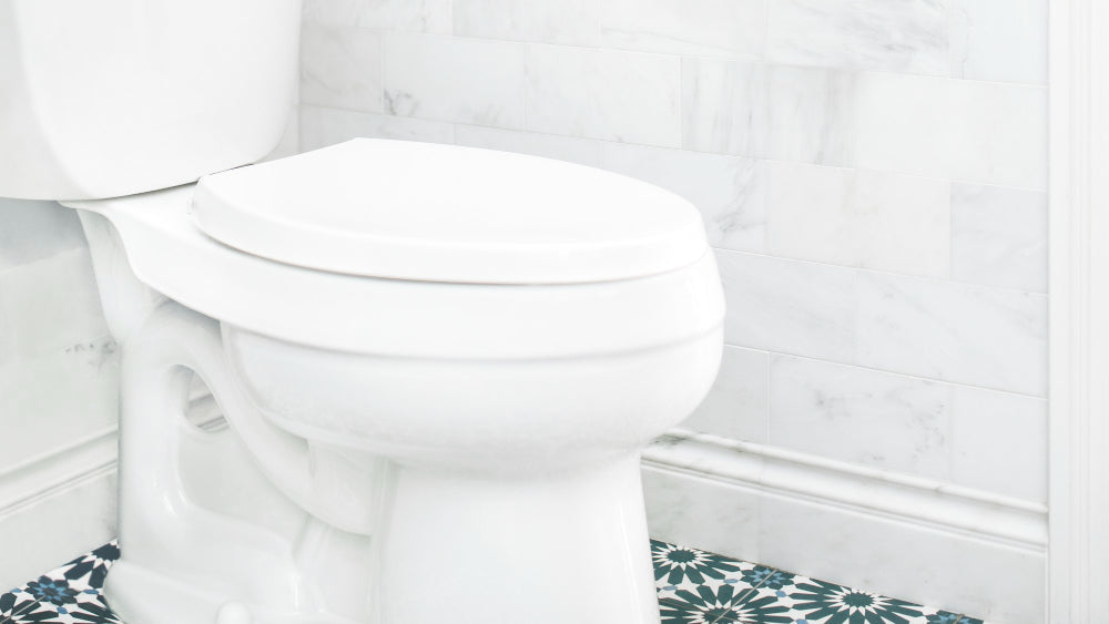 “Modern toilet in a clean bathroom setting, representing answers to frequently asked toilet-related questions.”