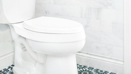 “Modern toilet in a clean bathroom setting, representing answers to frequently asked toilet-related questions.”