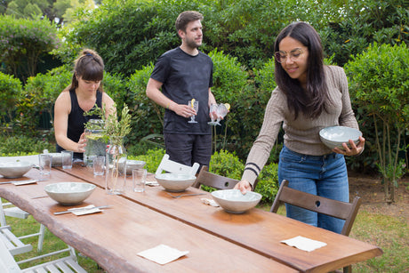 “Person constructing a wooden outdoor table using pre-cut timber, drill, and screws in a backyard DIY project.”