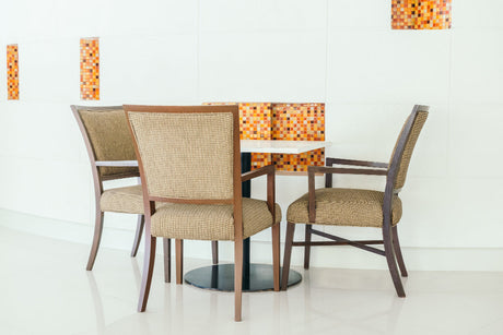 “Handmade seat cushions in various fabrics and patterns on kitchen and dining chairs, adding comfort and style through DIY projects.”
