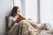 “Electric blanket laid flat over a mattress topper on a bed, demonstrating safe layering for warmth and comfort.”
