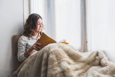 “Electric blanket laid flat over a mattress topper on a bed, demonstrating safe layering for warmth and comfort.”