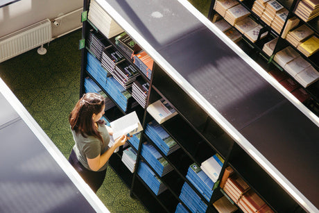 "Stylish 2025 bookcase design trends featuring open shelving, mixed materials, bold colors, and multifunctional storage for modern home libraries."
