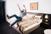  "Couple resting peacefully on a king size mattress, with one partner moving without disturbing the other—illustrating motion isolation benefits."