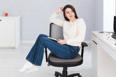 “Person applying a plastic cylinder clamp to the gas lift of an office chair to prevent it from sinking.”