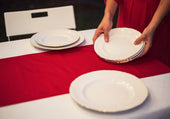 “Elegant buffet table setup with layered serving dishes, floral centerpiece, and decorative trays arranged for functional and aesthetic appeal.”