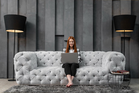 "Modern living room showcasing 2025 sofa design trends including curved silhouettes, bold upholstery, modular layouts, and sustainable materials."