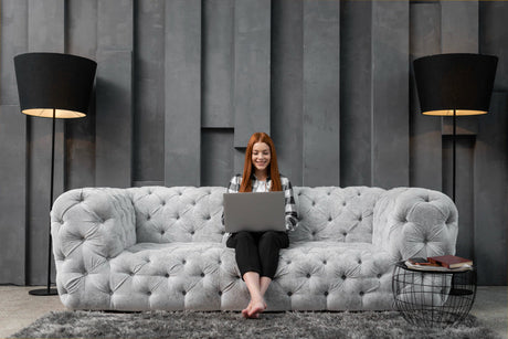 "Modern living room showcasing 2025 sofa design trends including curved silhouettes, bold upholstery, modular layouts, and sustainable materials."