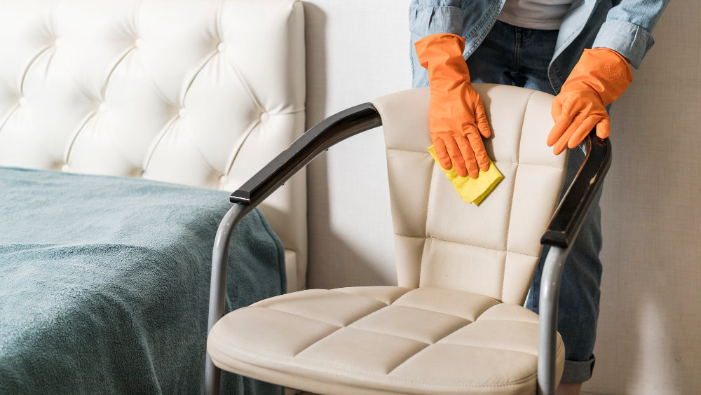 “Person cleaning a fabric dining chair with a soft brush and upholstery cleaner to remove stains and refresh the fabric.”