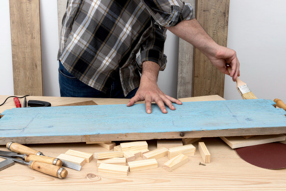“DIY fabric headboard being assembled with a wooden frame, foam padding, and upholstery stapled neatly in place.”