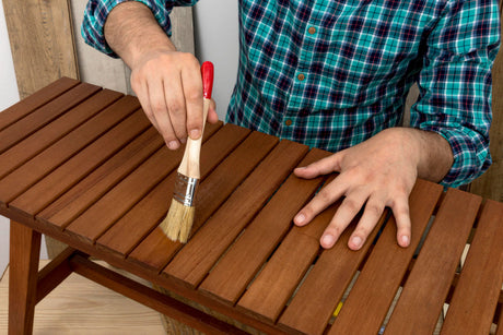 “Wooden dining table being sealed with a protective finish to enhance durability and preserve its natural beauty.”