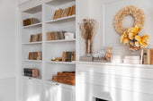“Well-styled bookcase with a mix of books, decorative objects, framed art, and plants arranged for visual balance and interest.”