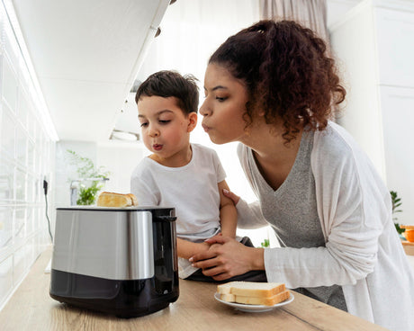 "Busy family kitchen with an air fryer preparing multiple quick dishes like salmon, veggies, and fries for an easy weeknight dinner."