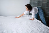 “Comfortable bed with a plush mattress topper added on top, enhancing support and softness for improved sleep quality.”
