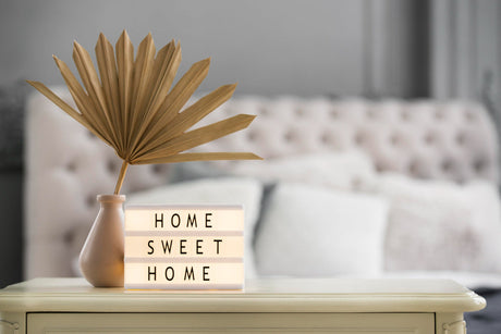 "Stylish 2025 bedroom with trending bedside tables featuring mixed materials, bold colors, and sleek minimalist design."