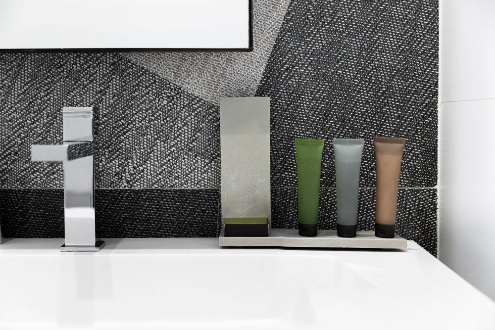 “Bathroom cabinets refreshed with new hardware, a fresh coat of paint, and decorative accents for a modernized look without full replacement.”