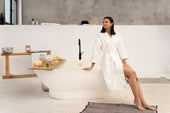 “Luxurious home spa setup featuring a freestanding bathtub with candles, plants, and soft lighting for a relaxing retreat.”