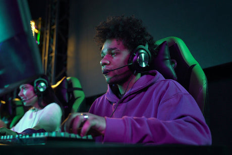 "Professional gamer focused in an ergonomic gaming chair with headrest, lumbar support, and RGB lighting, enhancing posture and performance during gameplay."