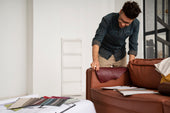 “Sofa being reupholstered with new fabric, foam, and tools laid out—highlighting the process and cost factors involved.”