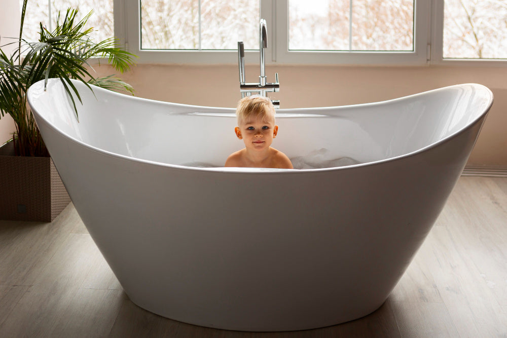 “Modern bathroom with a freestanding bathtub, styled with towels and bath accessories—representing expert answers to common tub-related questions.”