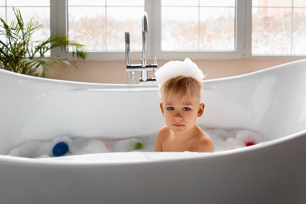 “Row of bathtubs made from different materials including acrylic, fiberglass, cast iron, and stone resin, displayed in a showroom setting.”
