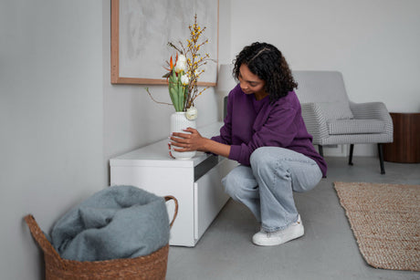 “Well-maintained wooden bedside table with protective pads and coasters to prevent damage.”