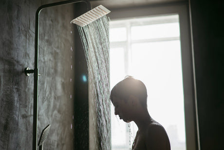 “Person replacing a shower head and attaching a new shower screen in a modern bathroom setup using basic tools.”