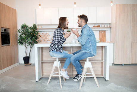 “Coordinated kitchen and dining setup featuring matching wooden bar stools and dining chairs for a seamless, stylish look.”