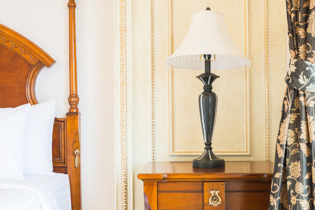 "Side-by-side comparison of a modern minimalist bedside table and a traditional ornate wooden bedside table in styled bedrooms."