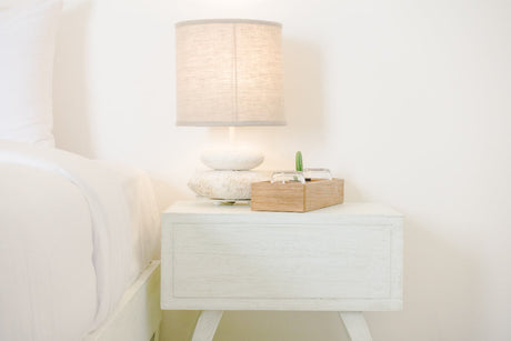 "Modern bedroom with coordinated bedside tables enhancing symmetry, lighting, and overall room design."