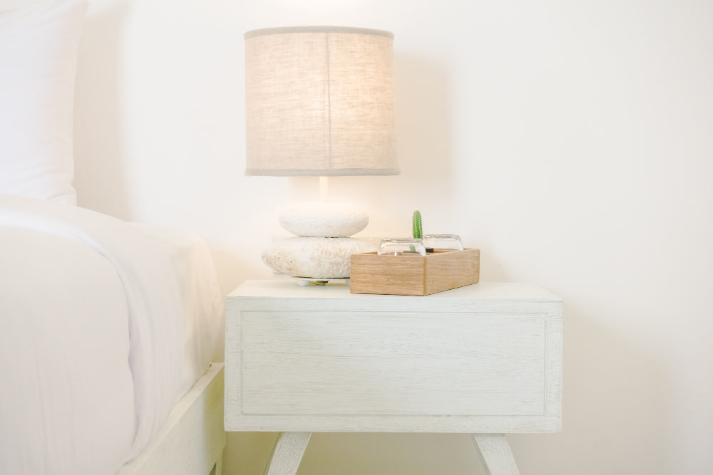 "Modern bedroom with coordinated bedside tables enhancing symmetry, lighting, and overall room design."