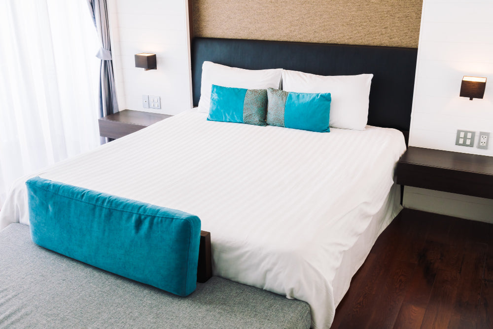“Couple relaxing on a queen size bed with soft bedding, showcasing the perfect balance of space and intimacy a queen mattress provides.”