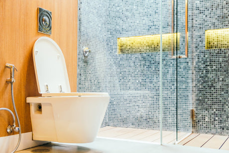 “Modern toilet paired with a sleek bidet attachment in a clean, upscale bathroom—showcasing a premium hygiene upgrade.”