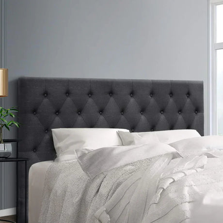 “Bed with an upholstered headboard positioned behind the pillows, serving both decorative and functional purposes in the bedroom.”