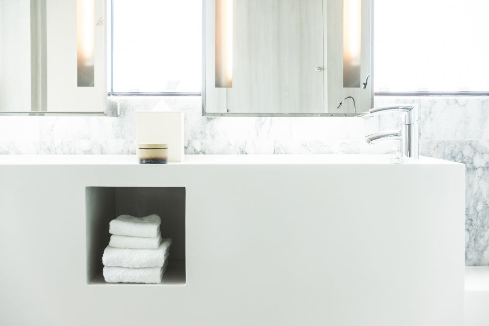 "Contemporary bathroom with sleek wall-mounted and under-sink cabinets, showcasing smart storage solutions for a clutter-free space."