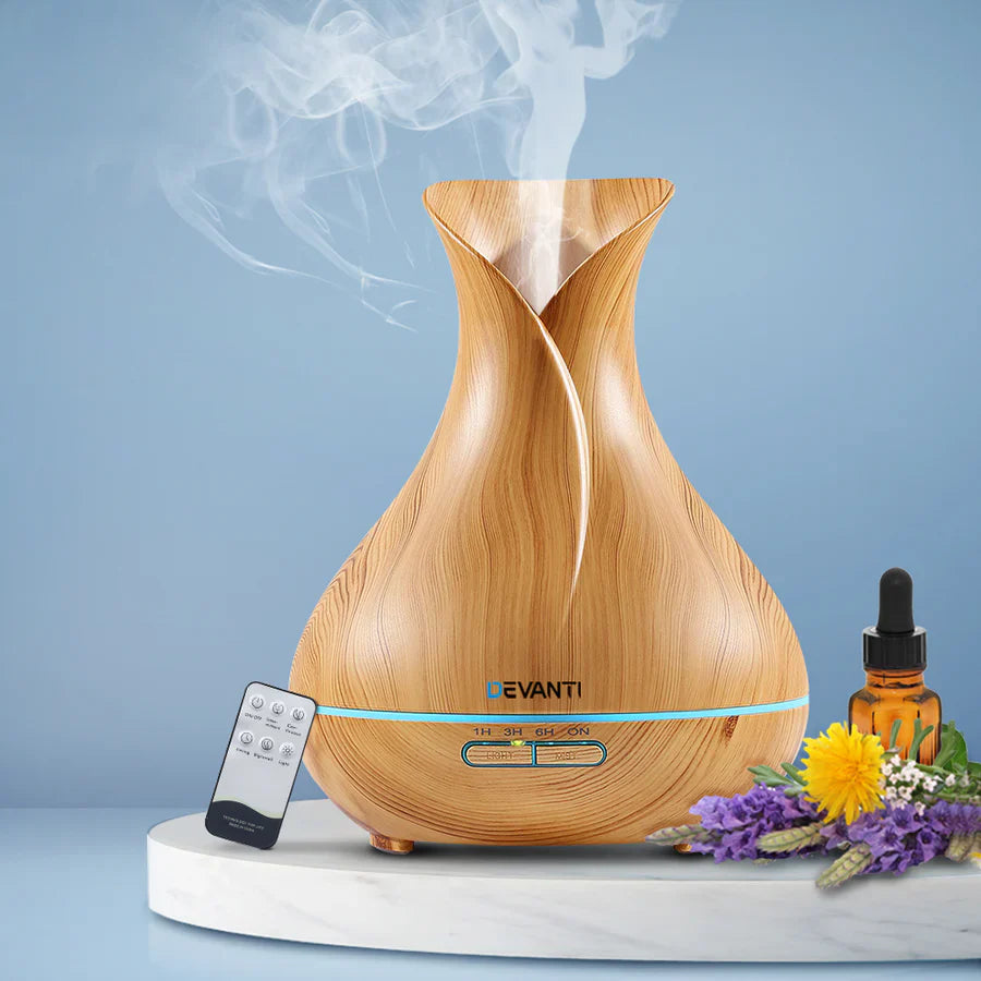 "Image of a humidifier with a bottle of essential oil nearby and a caution sign, illustrating that adding essential oils directly to most humidifiers can damage the device and pose health risks."