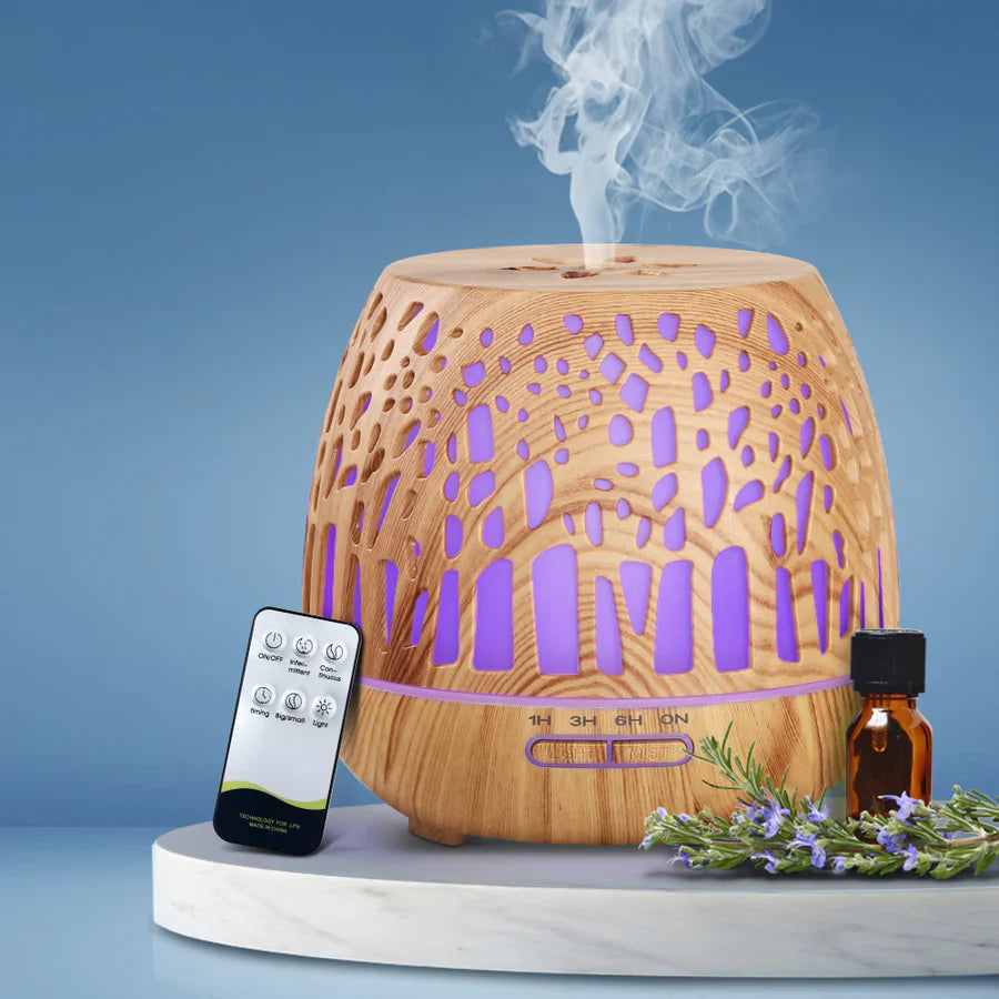 "Ultrasonic humidifier emitting visible mist from its top, showing water tank and control knobs, illustrating how the device adds moisture to the air by creating fine water droplets."