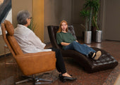 "Person enjoying a massage chair session at home, with icons highlighting health benefits like stress relief, improved circulation, and muscle recovery."