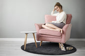 "Various armchairs styled with cozy throws, pillows, and rugs, showcasing different setups for ultimate comfort and relaxation."