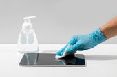 "Person gently wiping a tablet screen with a microfiber cloth, demonstrating safe cleaning methods to protect the display."