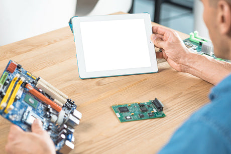  "Side-by-side comparison of a tablet chip and a laptop processor on circuit boards, emphasizing differences in size, power efficiency, and performance capabilities."