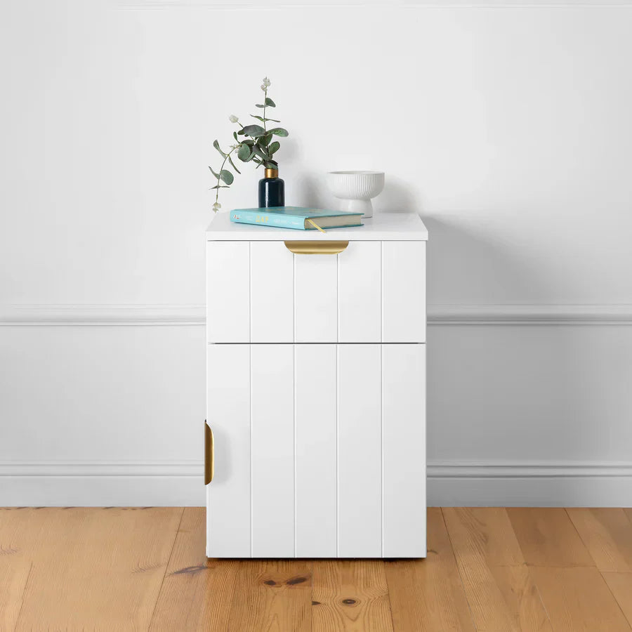 Close-up of various bedside tables made from different materials like wood, metal, and glass, placed beside beds in cozy bedrooms, showcasing their unique textures and ease-of-cleaning features.