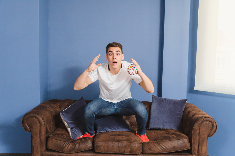 "Person cleaning and inspecting a recliner, demonstrating care techniques to maintain upholstery, mechanics, and appearance."