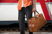 "Modern duffel bag packed for travel, placed on a bench with travel essentials, highlighting its versatility and spacious design."