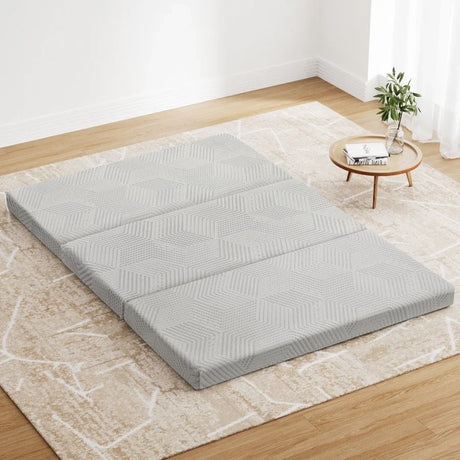 "Foldable double mattress neatly set up in a guest room, highlighting space-saving design and easy storage for occasional use."