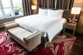 "Elegant bedroom with a premium king size mattress, showcasing plush layers, upscale materials, and refined design for maximum comfort."