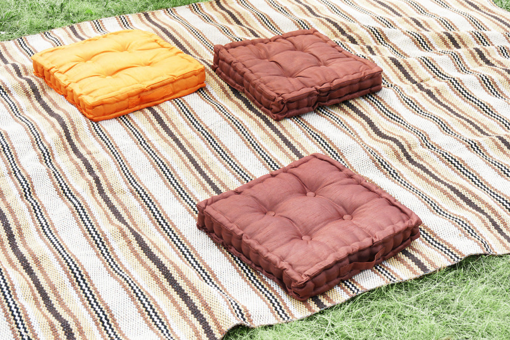 "Stylish outdoor rug on a patio with seating and plants, adding comfort, color, and definition to the exterior living space."